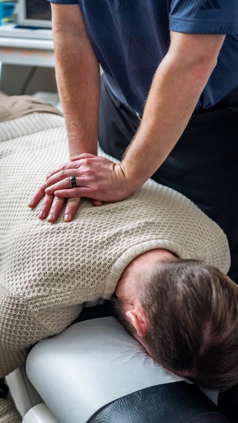 Chiropractor performing spinal adjustment and hands-on care