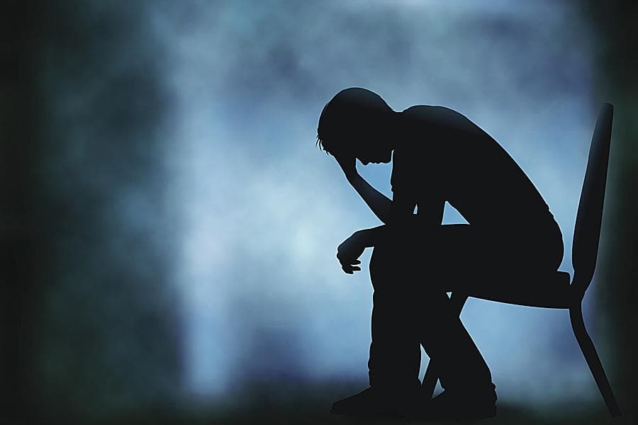 Silhouette of a person sitting alone in a somber blue atmosphere — depression, mental health struggle, and mood, Nektalov Chiropractic & Wellness, Forest Hills Queens NY