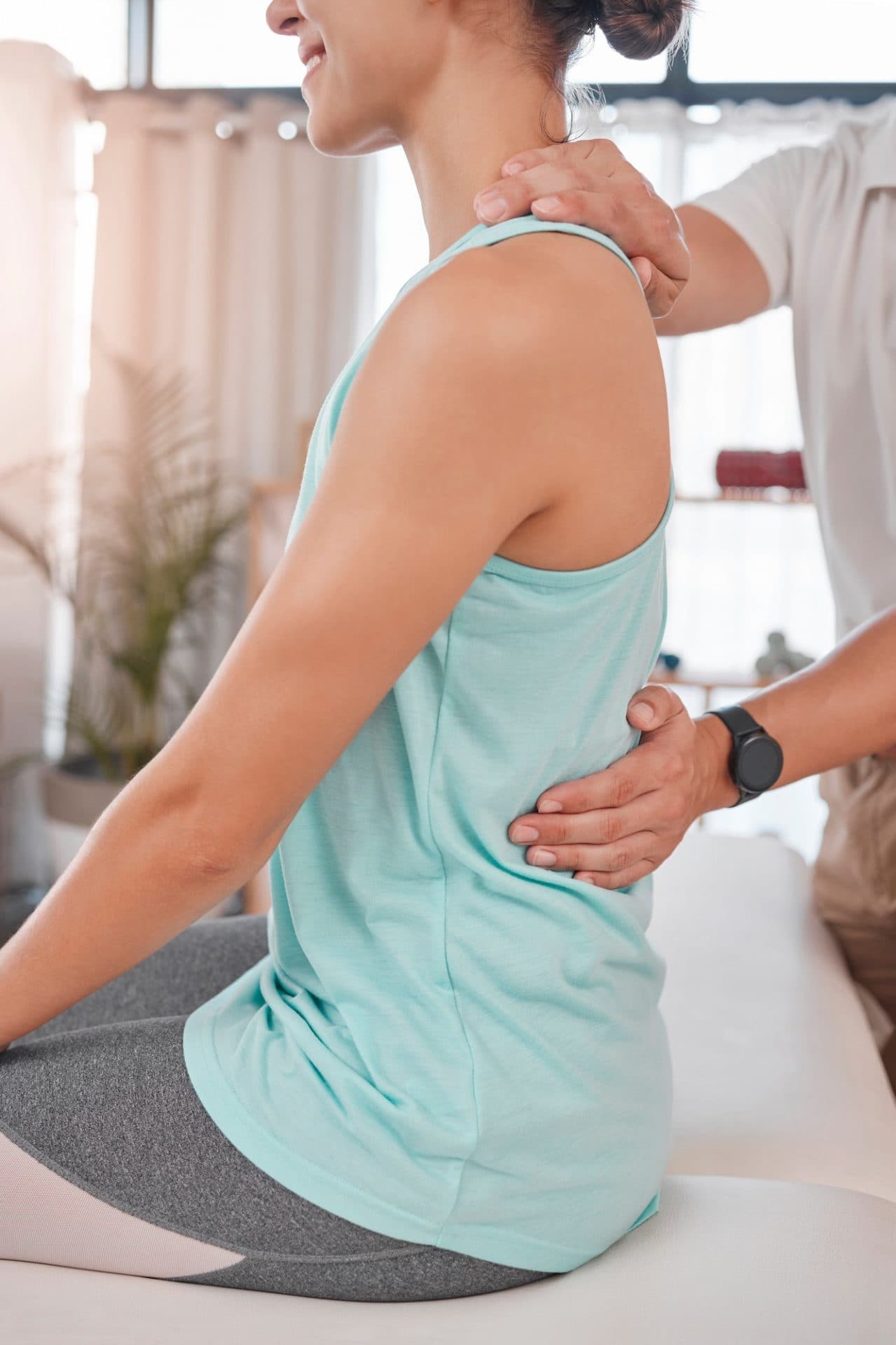 chiropractor-physiotherapy-and-back-pain-of-woman-while-at-physiotherapist-for-a-massage-physical-e1683516302103.jpg