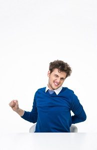 Handsome businessman sitting at teh table with back pain