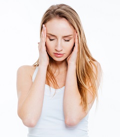 Young woman having headache isolated on a white background