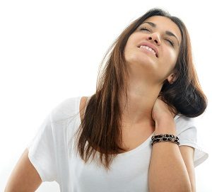 Handsome young caucasian girl isolated on white holding her neck